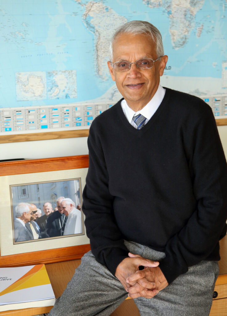 Ramanathan in front of world map.