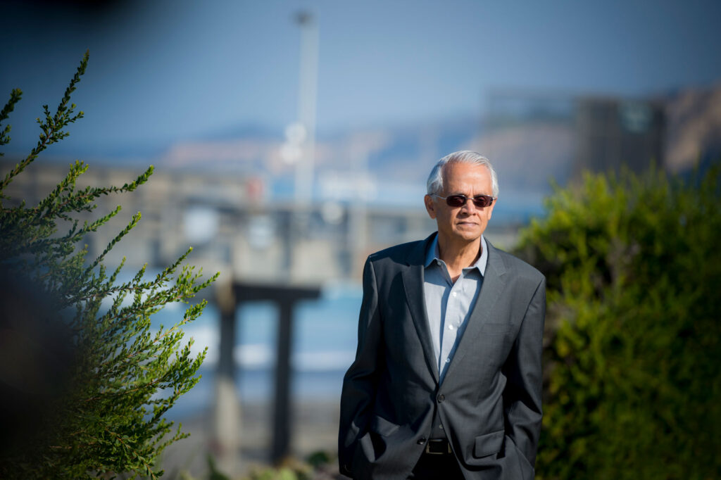 Ramanathan outside in front of the sea